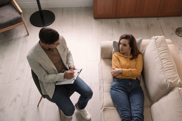 Canvas Print - Professional psychotherapist working with patient in office, above view