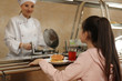 © New Africa - Little girl with plastic tray near serving line in canteen. School food