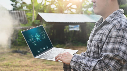 Agriculture technology attractive farmer navigating farmland with laptop computer  innovations for increasing productivity in agriculture.