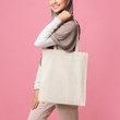 © Prostock-studio - Mockup image of muslim girl holding blank canvas tote bag