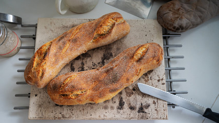 Top view of of two freshly baked home made sourdough baguettes