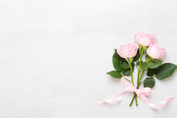 Flowers valentine day composition. Frame made of pink rose on gray background. Flat lay, top view, copy space.