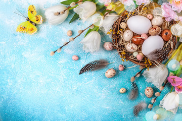 Easter composition with Easter eggs in nest,pussy willow branches and white tulips