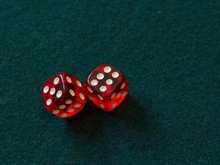 red dices on green cloth casino gambling luck