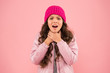 © be free - she has sore throat. cold climate weather. happy little girl pink background. kid puffer jacket and knitted hat. winter shopping. how to dress warm in winter. ready for cold winter. no flu