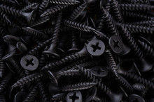 Full Frame Textured Background  - Pile Of New Metal Black Screws In Close-up