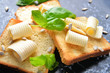 Fresh bread with butter and basil on board, closeup