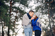 © hetmanstock2 - Couple in a winter forest. Beautiful girl in a blue sweater.