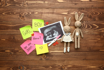 Sticker - Pregnancy test, sonogram image and toys on wooden background