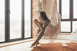 © Alena Ozerova - Woman wearing cashmere nightwear relaxing in cabin near fireplace