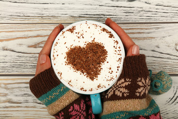 Wall Mural - Woman hands hold full latte cappuccino coffee cup