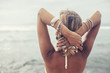 © Alena Ozerova - Back view of boho girl looking on the beach in Bali