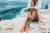 Fototapeta Boho - Boho girl wearing indian silver jewelry on the beach