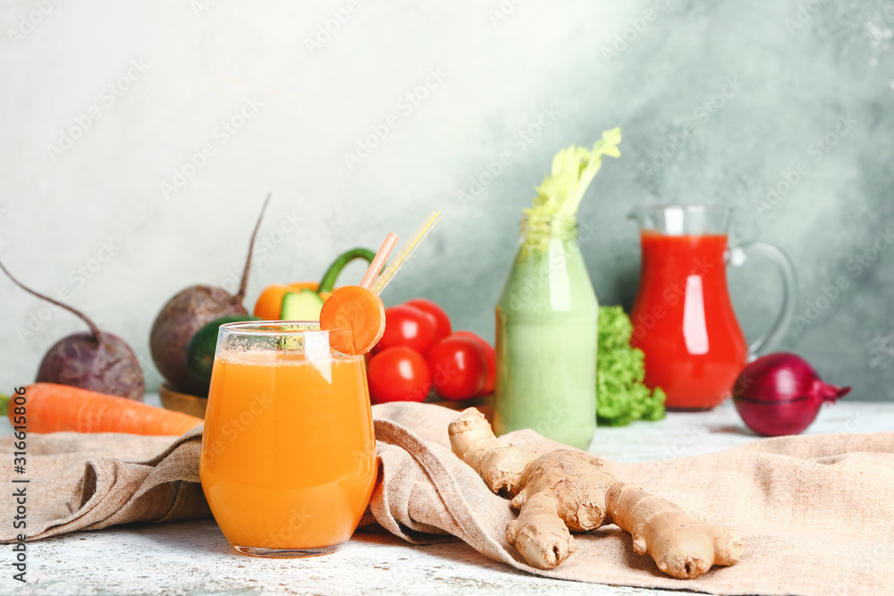 Glass of fresh vegetable juice on table