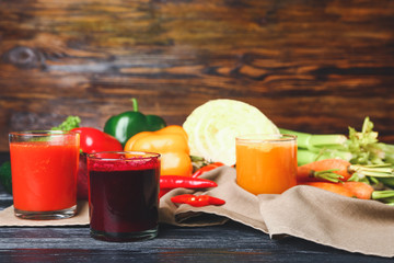 Glasses of fresh vegetable juices on table