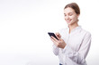 © Kuz Production - Smiling enthusiastic businesswoman in white blouse texting via smartphone isolated white background copyspace
