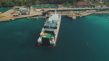 Aerial Top Drone Flight Over Big Ferry Boat Sailing To The Island Harbor In Tropical Nusa Penida, Bali Island, Indonesia. Blue Crystal Water. Travel Vacation Tourism