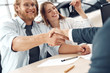 © Viktoriia - Two men shaking hands while happy woman holding key from new car