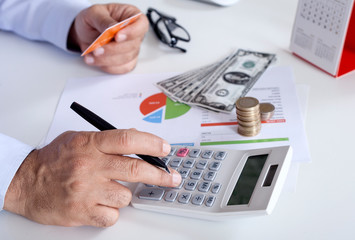 businessman using calculator