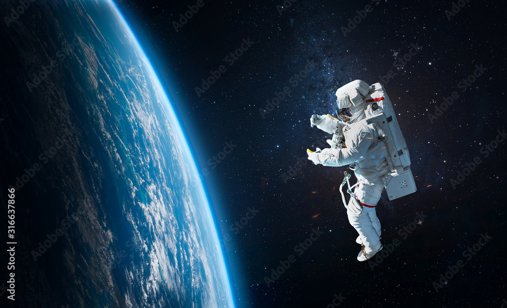 Astronaut in the outer space over the planet Earth. Abstract wallpaper. Spaceman. Elements of this image furnished by NASA - obrazy, fototapety, plakaty 