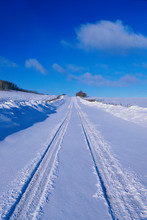 This Is The Last Dollar Road In Snow. It Is At The Dallas Divide In The San Juan Mountains. It Shows A Road With Freshly Fallen Snow With Car Tracks Indented In The Snow.