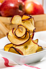 Wall Mural - Baked Cinnamon Red Apple Chips. Selective focus.