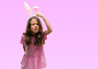 Poster - Brunette hispanic girl wearing easter rabbit ears annoyed and frustrated shouting with anger, crazy and yelling with raised hand, anger concept