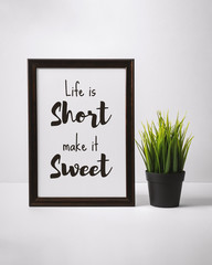 Wall Mural - Motivational and Inspirational Quotes. Life is Short Make it Sweet. Still Life of Word Frame on Work Desk.