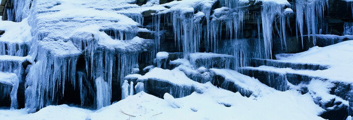 Wall Mural - These are Icicles in the Sierra Mountains in winter. The icicles overhang the ledges they are formed upon.