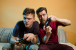 © phoenix021 - Intense video game situation, two friends in the middle of the game with controllers