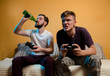 © phoenix021 - Men having fun, drinking beer and playing video games