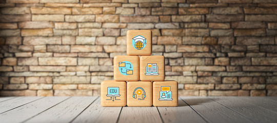 Wall Mural - cubes with e-learning symbols in front of a brick wall