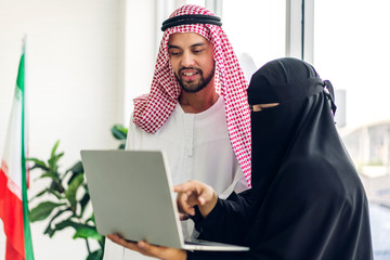 Wall Mural - Two arabic business people working with laptop computer.creative arab business people planning at modern work loft