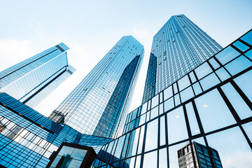 Modern skyscrapers in business district against blue sky