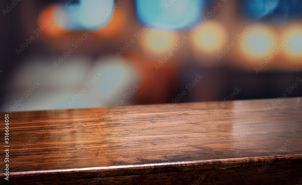 nightclub background.Empty diagonal brown wooden table with blur bar restaurant bokeh lights,banner mockup template for display of product - obrazy, fototapety, plakaty 