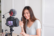 © weedezign - Asian young female blogger recording vlog video with makeup cosmetic at home online influencer on social media concept.live streaming viral