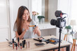 © weedezign - Asian young female blogger recording vlog video with makeup cosmetic at home online influencer on social media concept.live streaming viral