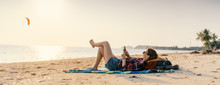 Young Woman Lying With Smart Phone On A Beach. Relaxation Concept