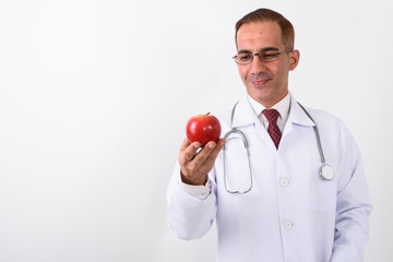 Portrait of mature handsome Persian man doctor