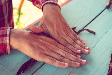 Cuban cowboy is making a cigar for tourists. Closeup of hands making cigar from tobacco leaves. Traditional manufacture of cigars.