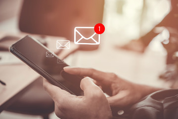 Woman hand use smartphone in public area with 1 new email alert sign icon pop up. Communication business technology.