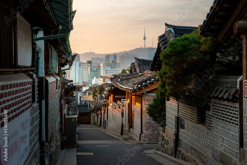 Traditional Korean style architecture at Bukchon Hanok Village with N Seoul Tower in background in Seoul, South Korea Canvas Print