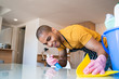 © Mego-studio - Young latin man cleaning at home.