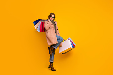 Poster - Full body photo of nice lady walking shopping center carry many packs addicted shopper wear specs casual pink coat pullover jeans leopard shoes isolated yellow color background