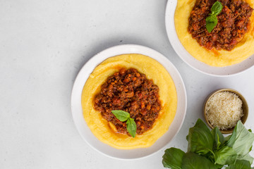 Wall Mural - Polenta (boiled cornmeal) with meat-based sauce -  ragù alla bolognese.