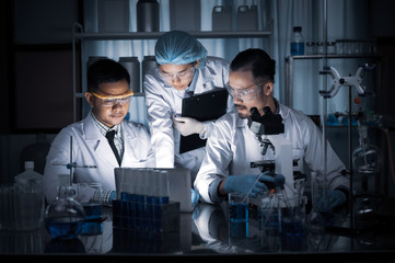 Wall Mural - in a modern laboratory scientists team conduct experiments, consisting of glassware test tubes and m