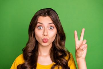 Poster - Close-up portrait of her she nice attractive lovely charming coquettish cheery wavy-haired girl showing v-sign sending kiss having fun isolated on bright vivid shine vibrant green color background