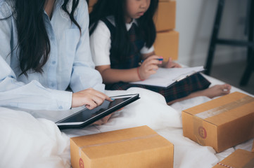 Young woman entrepreneur selling online product and use laptop in her workplace.