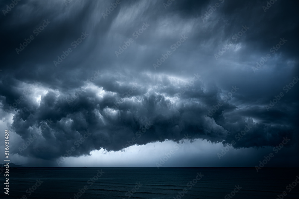 dark and dramatic stormy clouds over sea - obrazy, fototapety, plakaty 