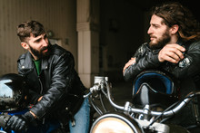 Photo Of Bearded Bikers Talking While Sitting On Their Bikes